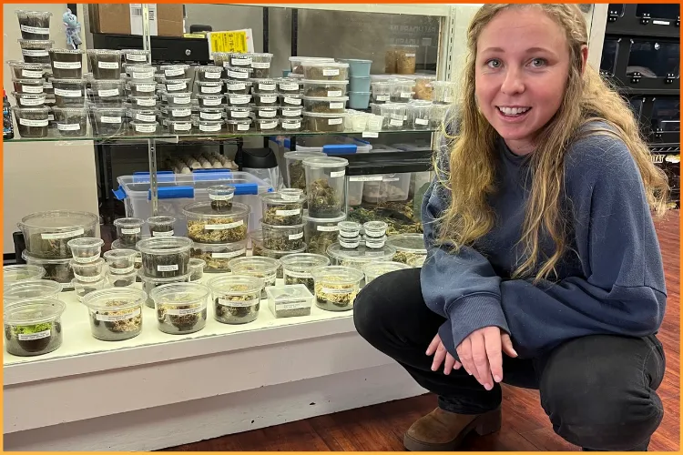 Boise Reptile Company co-founder Makena kneeling by feeding supplies for reptile support and guidance